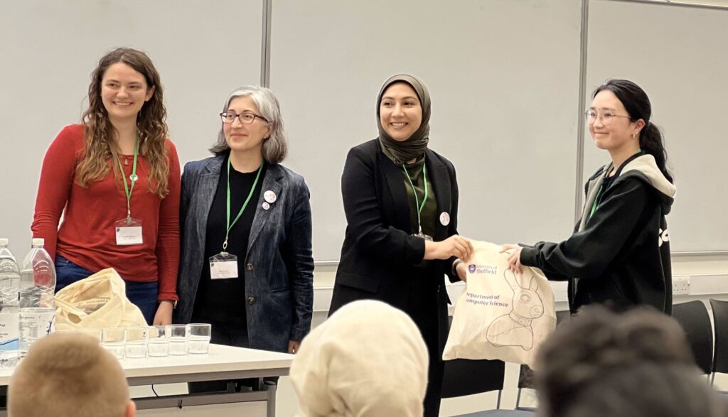 Alex Stanhope (Ocado Technology and also a Lovelace Alumna and also designer of our wonderful 8 bit ada logo), Safia Barikzai (Event chair) and Munira Raja (local chair) giving a prize goodie bag to Jasmine Kam of Aberystwyth University for People's Choice.